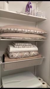 a closet with a stack of pillows and a toilet at Casa Di Luce in Montesilvano