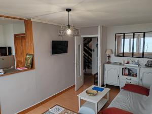 a living room with a couch and a table at O'2 cailloux in Le Tréport