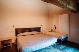 a bedroom with two beds in a room at Maison Rosset agriturismo, camere, APPARTAMENTI e spa in Valle d'Aosta in Nus