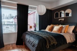 a bedroom with a large bed and a large window at Elite Studio - Work & Rest in Piteå