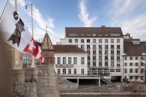 a british flag flying in front of a building at Riverside Hotel Merian - opening 2026 in Basel