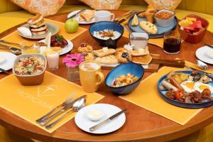 a table full of breakfast foods on a table at NH Bangkok Sukhumvit Boulevard in Bangkok