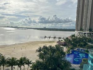 a view of a beach with two boats in the water at Muji-Inspired 2BR 2BA Apartment, 8 Mins to CIQ, Sleeps 2-6 in Johor Bahru