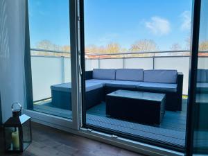 a balcony with a couch in a room with windows at Haus Water Jieper in Göhren-Lebbin