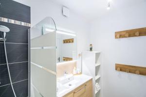 a bathroom with a shower and a sink and a mirror at New Splendid Appt Terrace - 5 min Disneyland Paris in Montévrain +41 photos