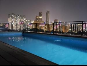 a swimming pool on top of a building with a city skyline at RPC Blissful Homes & Hotel in Kuala Lumpur