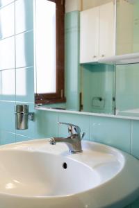 a bathroom with a white sink and a mirror at La Vittoria in Lido di Ostia