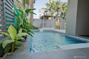 a swimming pool in the backyard of a house at The August Villas by HNH in Saligao