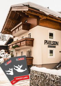 una casa con un cartel delante de ella en PHILSON Apartments en Saalbach Hinterglemm