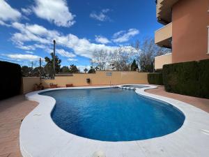 a swimming pool in front of a building at Vistamar 2-Serviden in Denia