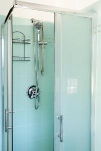 a shower with a glass door in a bathroom at La Vittoria in Lido di Ostia