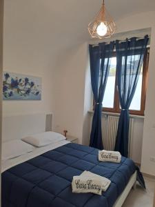 een slaapkamer met een blauw bed en blauwe gordijnen bij Casa concy in Sant'Agnello