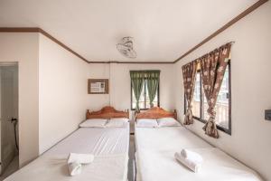 Postel nebo postele na pokoji v ubytování Zaniya's Pension