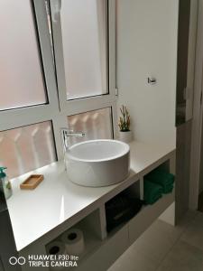 a bathroom sink with a white counter top at Hortas Residence 13 in Funchal