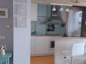 a kitchen with white cabinets and a stove at Rincón de Relax in Ocaña