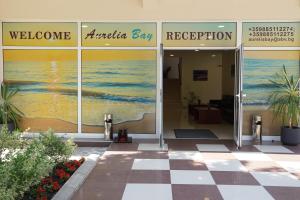 a lobby of a building with a painting of the ocean at Аурелия Бей in Ravda