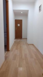 an empty room with a wooden floor and a door at Energy House in Jasło