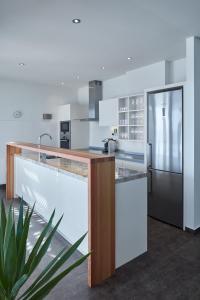 a kitchen with white counters and a refrigerator at Villa Roca in Vis
