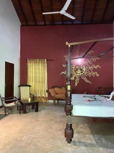 1 dormitorio con cama y pared roja en Traum Villa, en Bentota