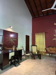 an office with a desk and chairs in a room at Traum Villa in Bentota