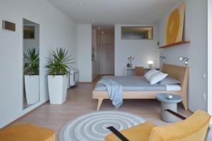 a bedroom with a bed and two chairs at Villa Roca in Vis