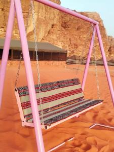 a swing in the middle of the desert at golden day in Wadi Rum