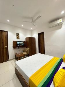 a bedroom with a large bed with a colorful blanket at THE LUXURY PLATINUM INN --Luxury Deluxe Rooms -- Chandigarh Road in Ludhiana
