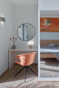 a bedroom with a desk with a chair and a mirror at Villa Roca in Vis