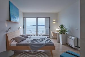 a bedroom with a bed and a view of the ocean at Villa Roca in Vis +25 photos