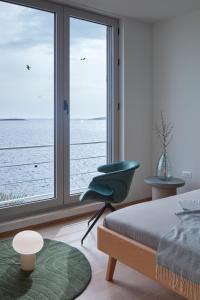 a bedroom with a bed and a window with a view of the ocean at Villa Roca in Vis