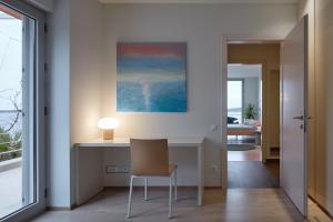 a desk with a chair in a room with a window at Villa Roca in Vis
