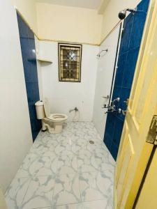 a bathroom with a toilet and a shower at Beautiful 2bhk near Hitech city in Kondapur