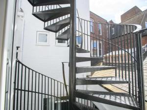 a spiral staircase leading up to a building at Pass the Keys Spacious Flat in the City Centre in Lincoln