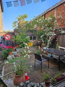 un jardín con macetas en una terraza de madera en Charming 2-room apartment with garden - 10 min from the centre of Paris and the Olympic Village, en Saint-Denis