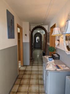 a hallway with a tile floor and an archway at Hotel Sonnenmatte Titisee B und B nahe Badeparadies in Titisee