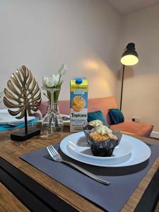 a table with a plate of food and a box of cereal at Tudors eSuites Budget Apartments in Birmingham