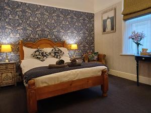 a bedroom with a bed with two teddy bears on it at Ashburton House - B&B in Scarborough