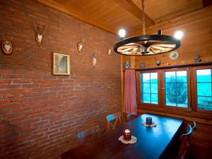 a dining room with a brick wall and a table at Chuderhuette in Wyssachen