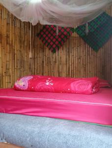 a pink pillow sitting on top of a pink mattress at Du Gia Wooden Homestay in Làng Cac