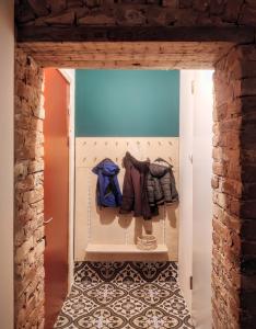 a room with a door with clothes on it at Unique design, hype location! in Rīga