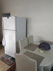 eine Küche mit einem Tisch und einem weißen Kühlschrank in der Unterkunft Private Room in Providence