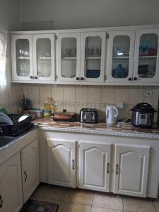 eine Küche mit weißen Schränken und einer Arbeitsplatte in der Unterkunft Private Room in Providence