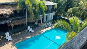 an overhead view of a resort pool with palm trees at Shell Resort in Arugam Bay
