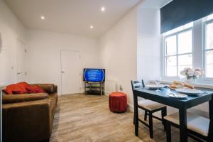 a living room with a couch and a table at Oak View in Bowness-on-Windermere