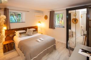 a bedroom with a bed and a walk in shower at Villa Claudia Hotel Cannes Centre - Parking in Cannes