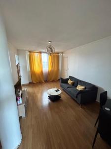 a living room with a couch and a table at Great room Saint-Denis (near Paris) in Saint-Denis