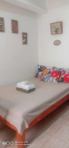 a bed in a white room with at Homey Studio Condo by Malou in Calamba