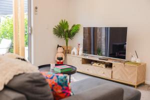 a living room with a couch and a tv at stylish and comfort in CBD in Christchurch