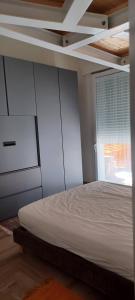 a bedroom with a white bed and a window at CASA LELA rimini SAN GIIULIANO in Rimini