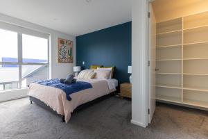a bedroom with a bed and a large window at stylish and comfort in CBD in Christchurch